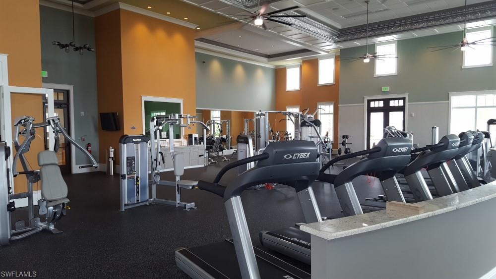 7270 Saona Court Naples, FL 34113 - Photo 27 of 46 a living room with lots of chairs and a chandelier