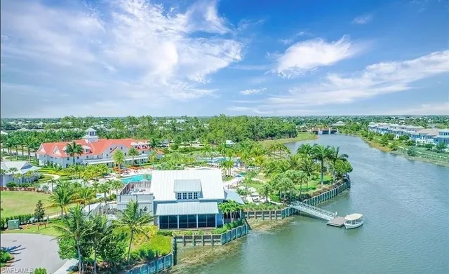 an aerial view of residential houses with outdoor space and swimming pool