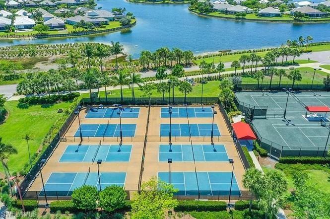 7270 Saona Court Naples, FL 34113 - Photo 32 of 46 an aerial view of residential houses with outdoor space and lake view