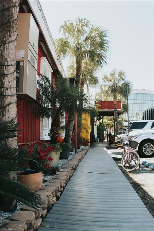 7270 Saona Court Naples, FL 34113 - Photo 37 of 46 a couple of table and chairs in front of building