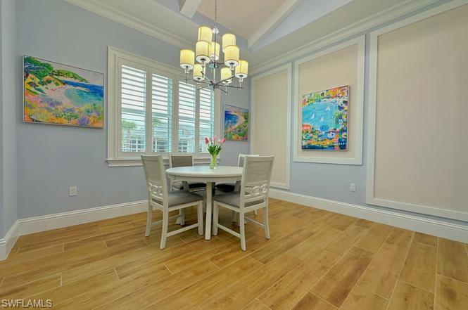 7270 Saona Court Naples, FL 34113 - Photo 4 of 46 a dining room with furniture a rug and a chandelier