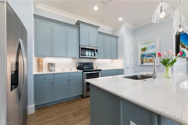 a kitchen with a refrigerator sink and microwave