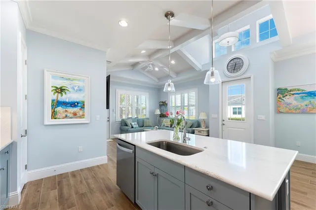 a view of a kitchen area with furniture and wooden floor