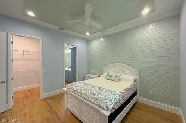 a bedroom with a sink and a mirror