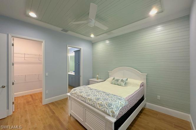 7270 Saona Court Naples, FL 34113 - Photo 8 of 46 a bedroom with a sink and a mirror