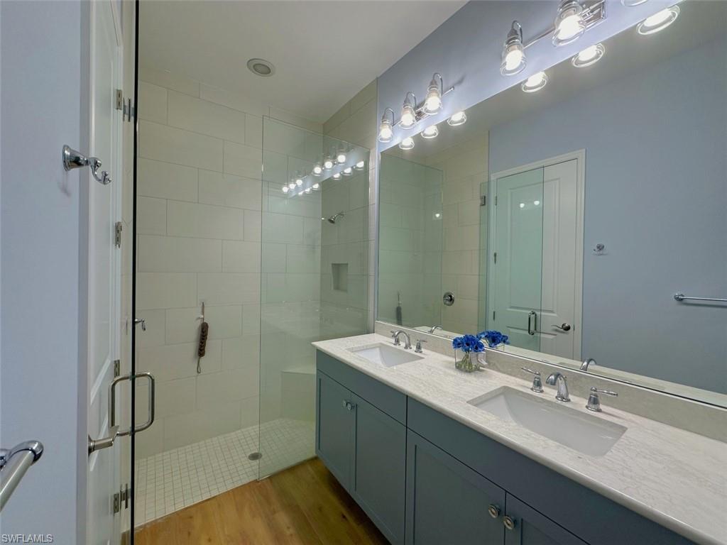 7270 Saona Court Naples, FL 34113 - Photo 9 of 46 a bathroom with a double vanity sink mirror and shower