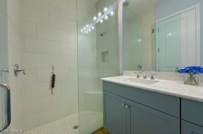 7270 Saona Court Naples, FL 34113 - Photo 10 of 46 a bathroom with a sink shower and a mirror