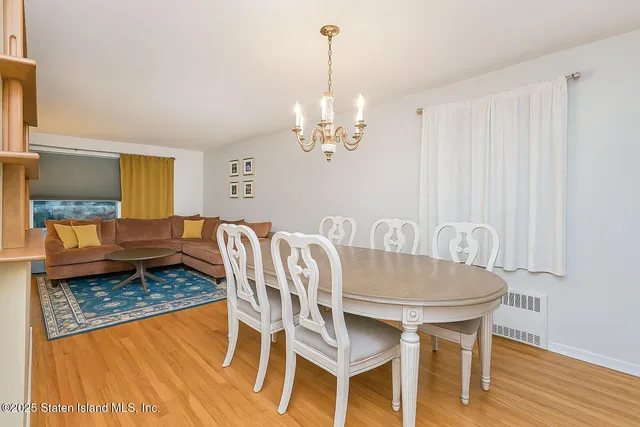 a view of a dining room with furniture wooden floor and chandelier