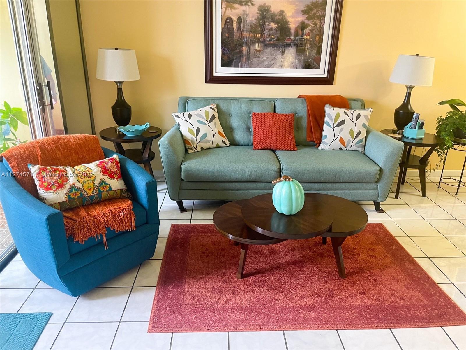 2811 North Pine Island Road, Unit 111 Sunrise, FL 33322 - Photo 13 of 16 a living room with furniture and a mirror