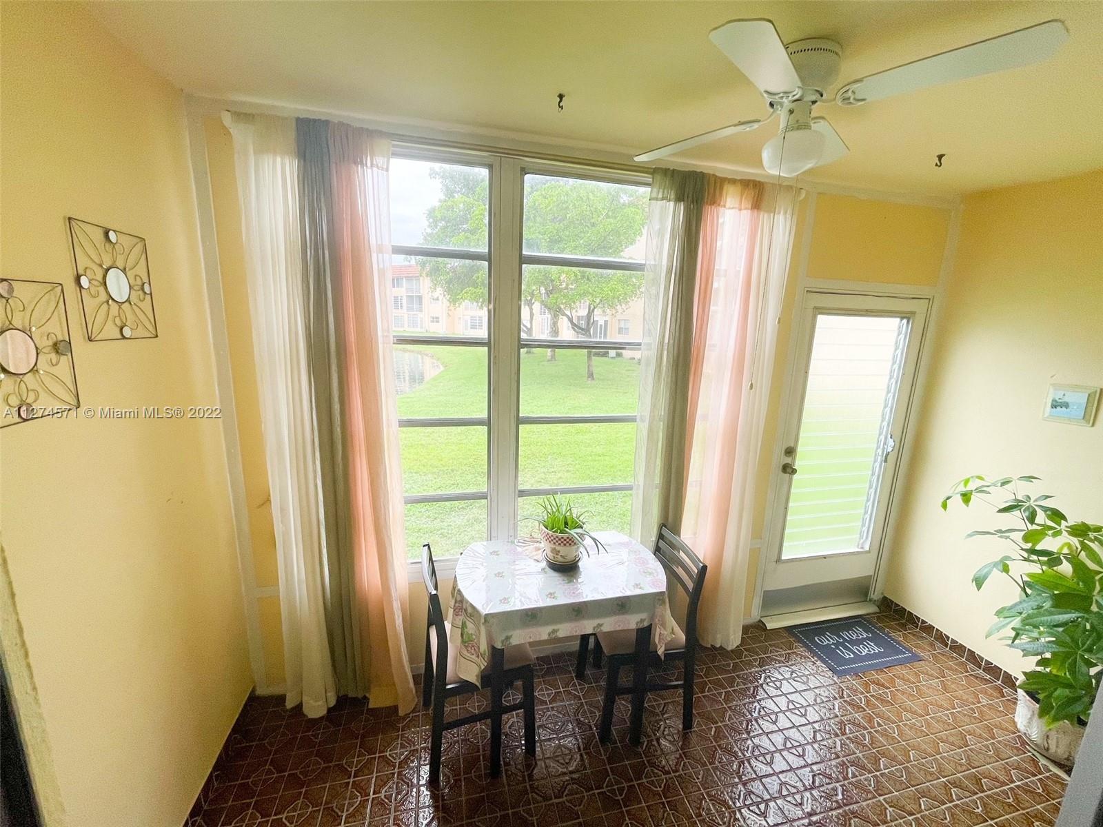 2811 North Pine Island Road, Unit 111 Sunrise, FL 33322 - Photo 15 of 16 a view of a workspace with furniture and a window