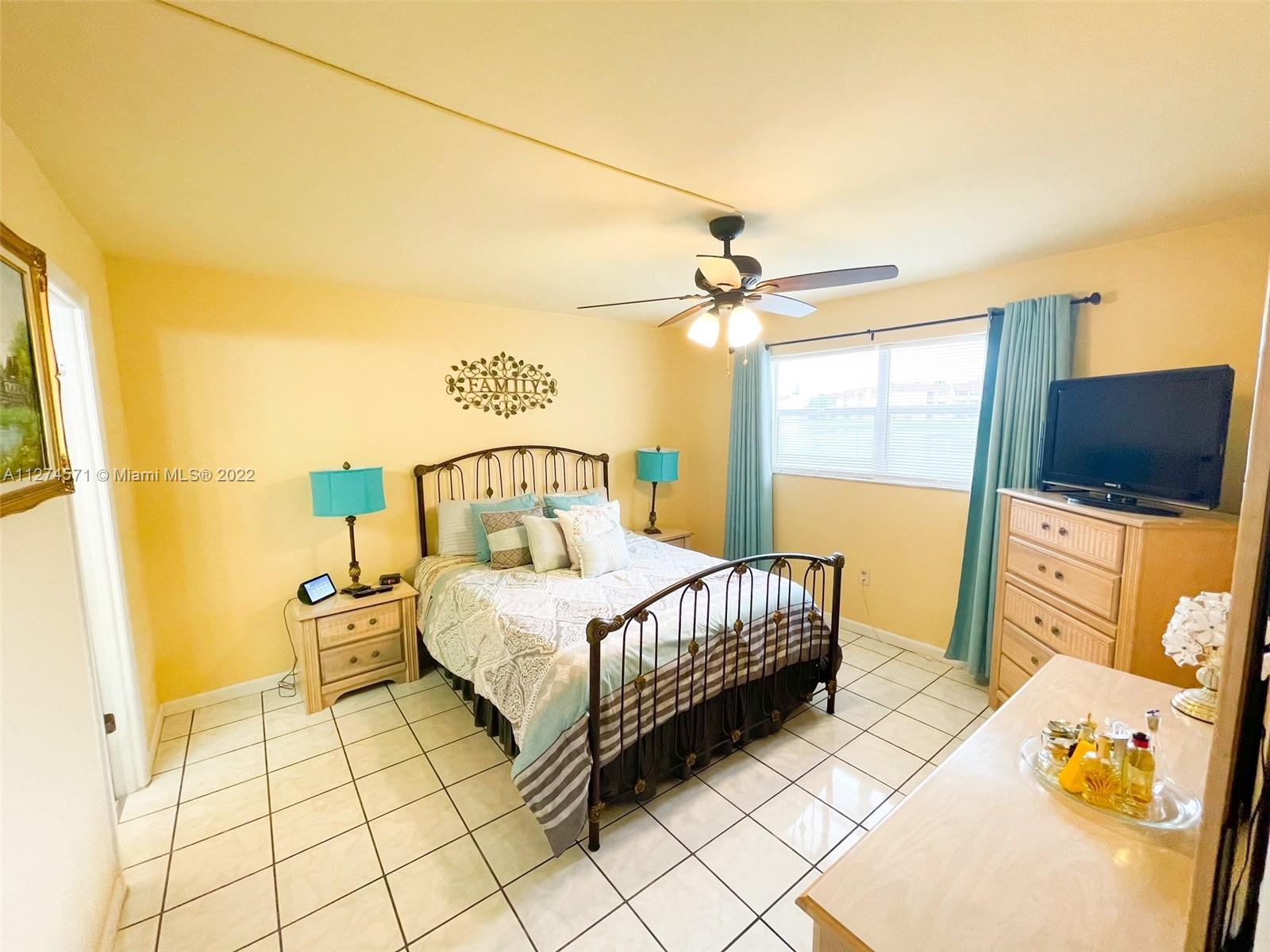 2811 North Pine Island Road, Unit 111 Sunrise, FL 33322 - Photo 5 of 16 a bedroom with a bed and wooden floor