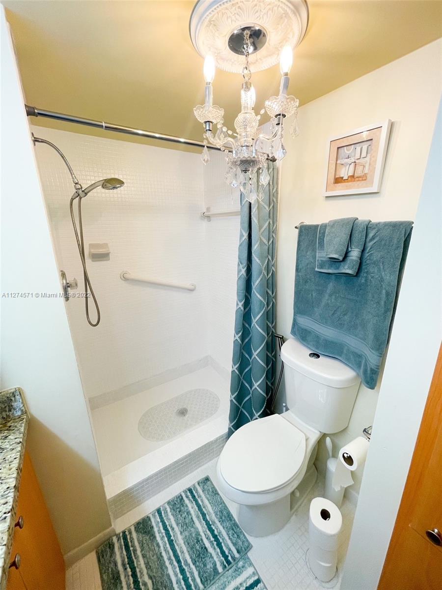 2811 North Pine Island Road, Unit 111 Sunrise, FL 33322 - Photo 7 of 16 a bathroom with a sink a toilet and shower