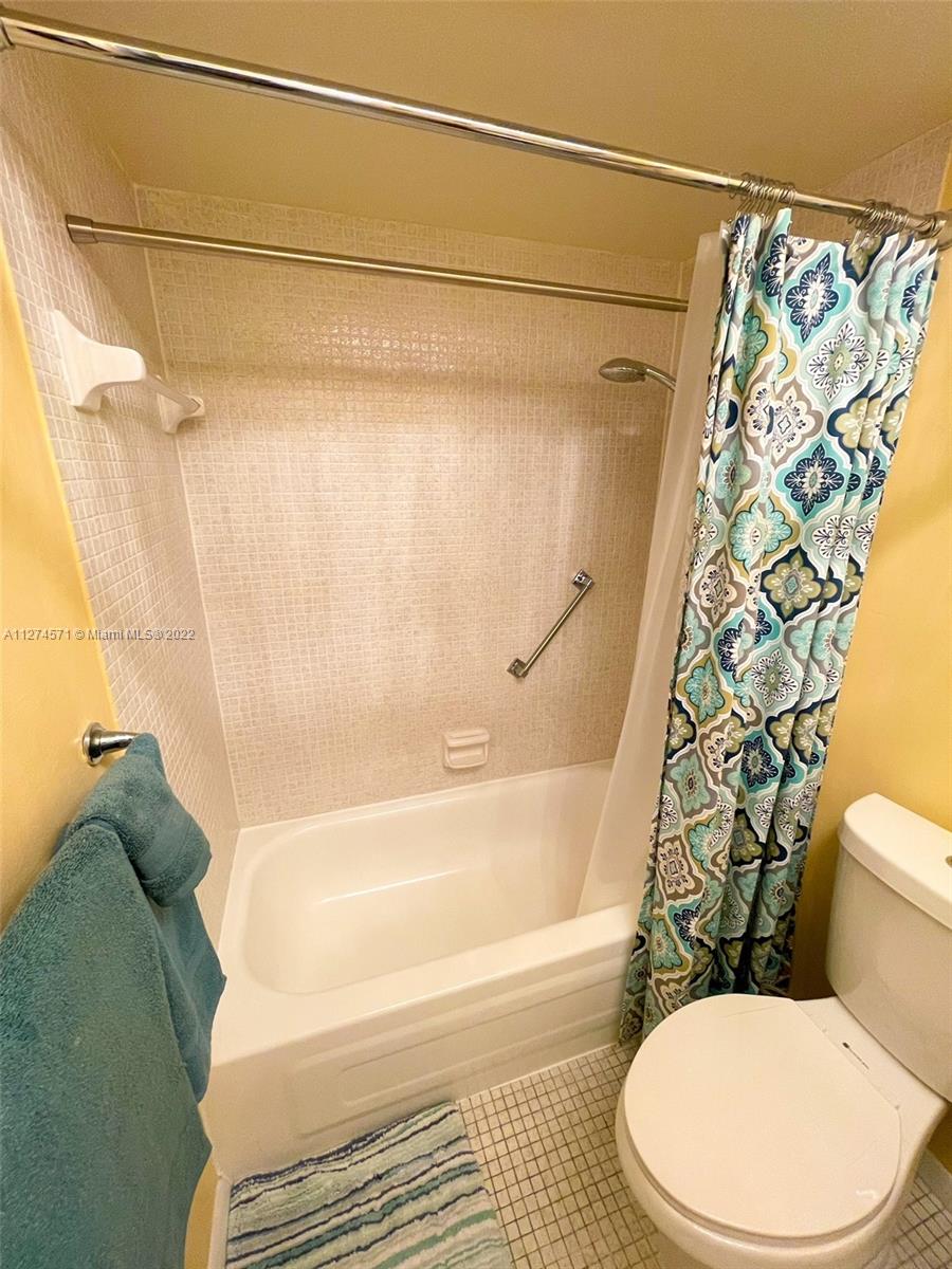 2811 North Pine Island Road, Unit 111 Sunrise, FL 33322 - Photo 10 of 16 a bathroom with a toilet and a bathtub