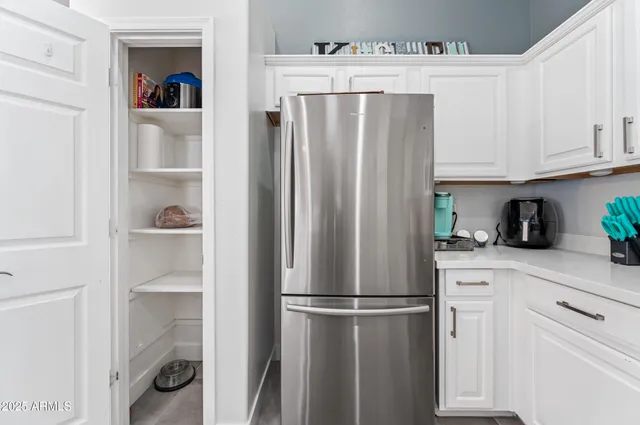 a white refrigerator freezer and a stove sitting inside of a kitchen