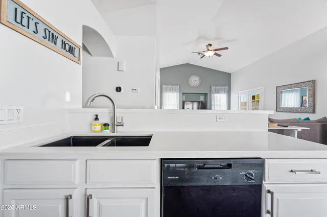 a kitchen with sink a faucet and appliances