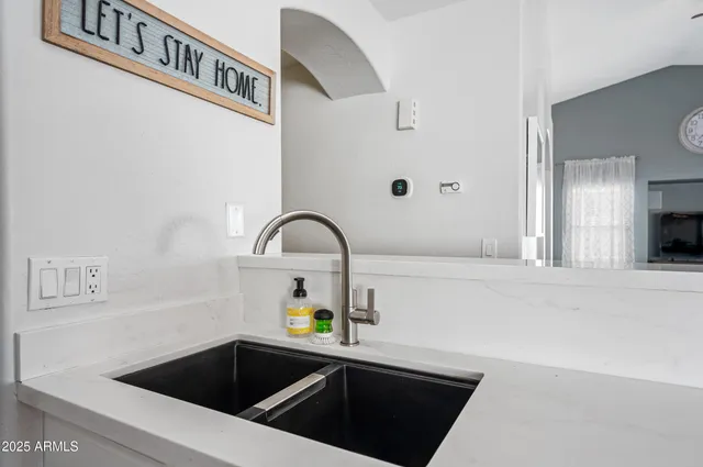 a view of a dining room with furniture a chandelier and wooden floor