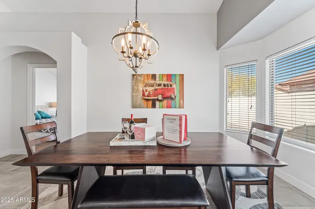 a view of a dining room with furniture wooden floor and a chandelier