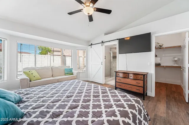 a bed sitting in a bedroom next to a window