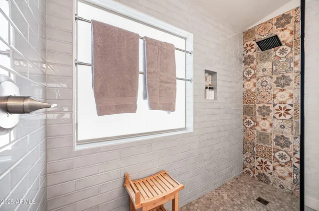 a bathroom with a shower and a curtain