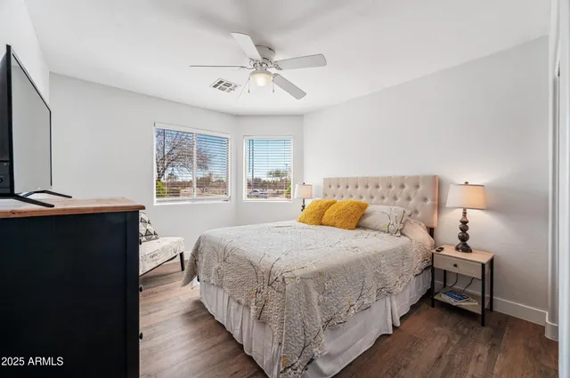 a view of a bedroom with wooden floor and cabinet