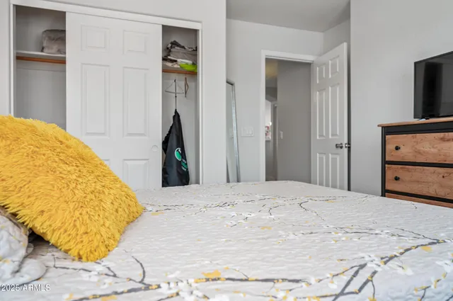 a bedroom with a bed and a window