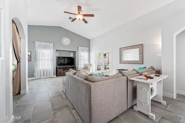 a living room with furniture a fireplace and a flat screen tv