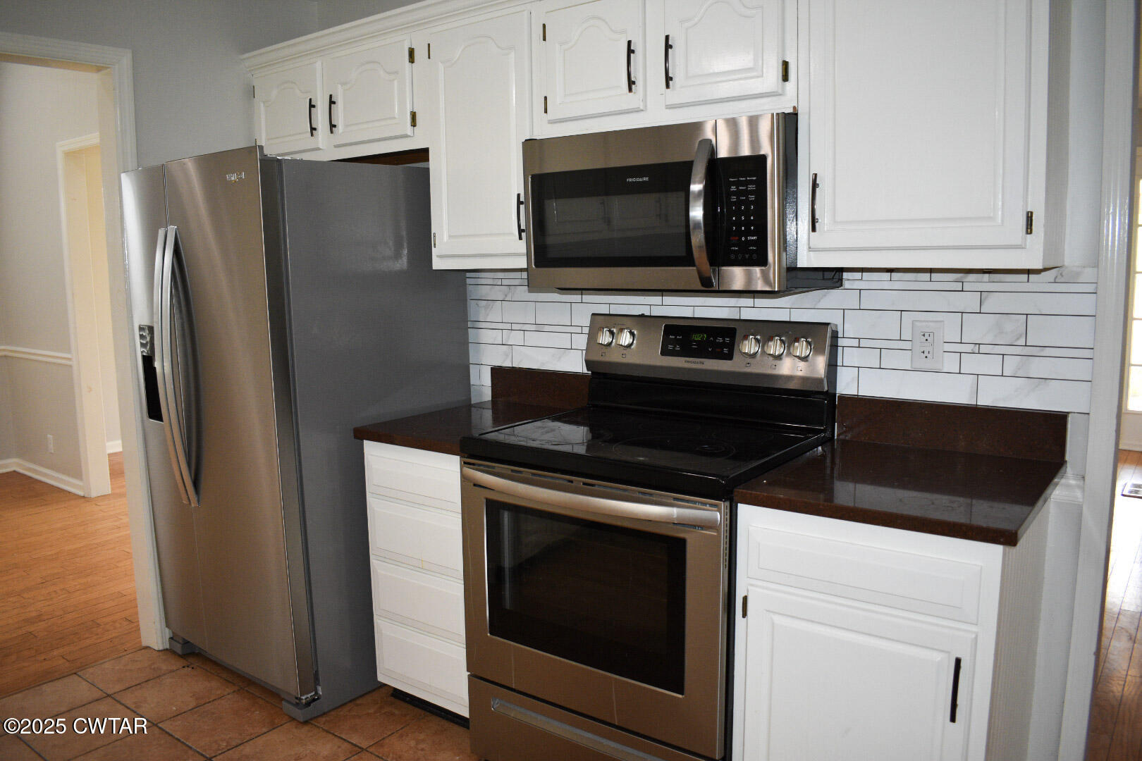 612 Wynridge Troy, TN 38260 - Photo 13 of 42 a kitchen with stainless steel appliances a stove a microwave and cabinets