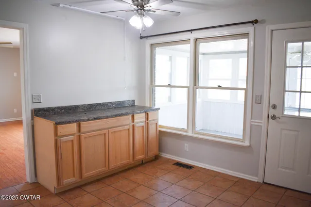 a view of a kitchen with a sink and dishwasher with wooden floor