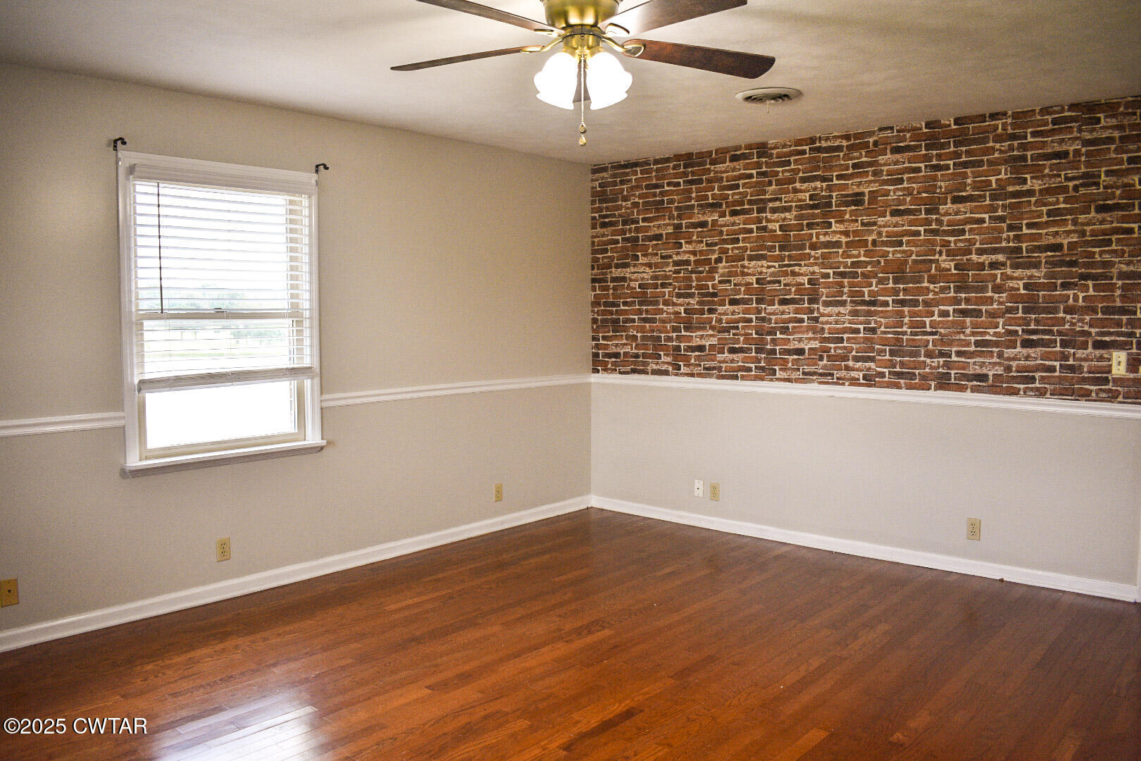 612 Wynridge Troy, TN 38260 - Photo 19 of 42 an empty room with wooden floor and windows