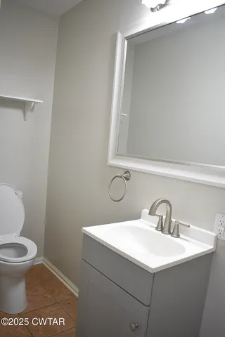a bathroom with a sink a toilet and mirror