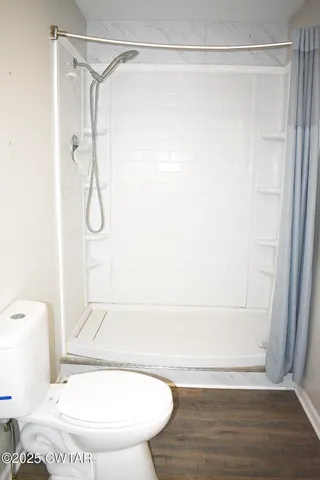 a bathroom with a shower and a sink