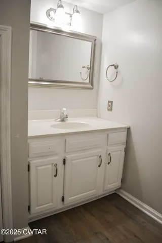 a bathroom with a sink a mirror and a vanity