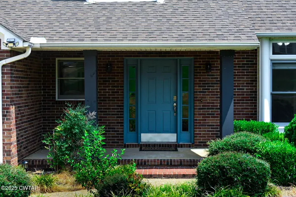 a front view of a house with plants
