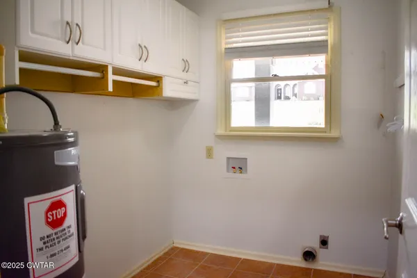 a view of storage and utility room with window