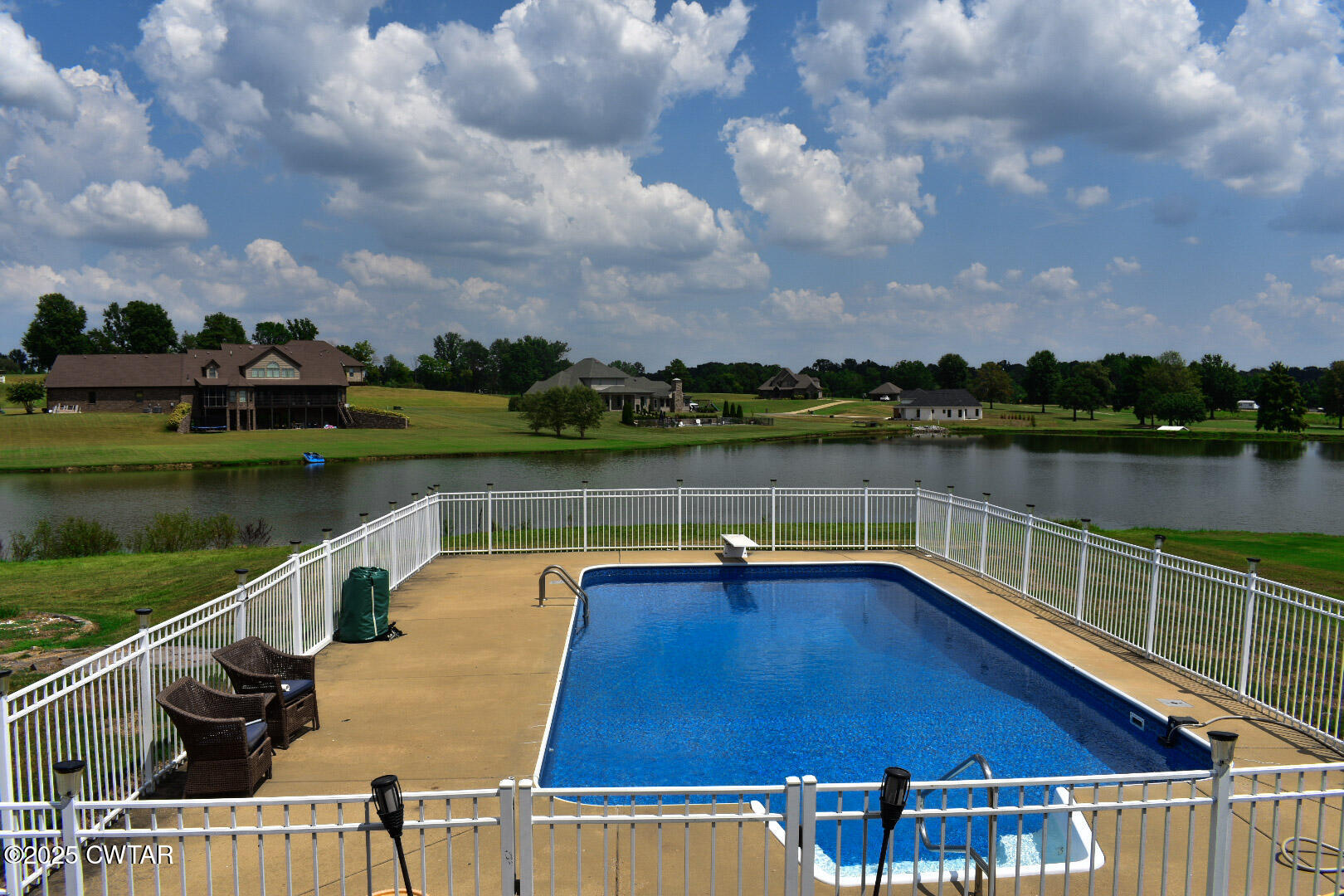 612 Wynridge Troy, TN 38260 - Photo 35 of 42 a view of swimming pool with lake and houses in the back
