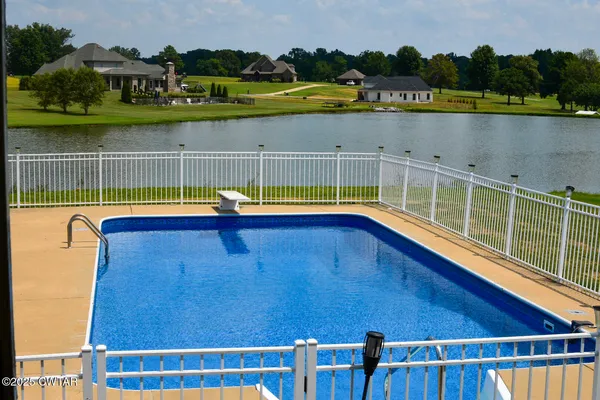 a view of a swimming pool with a lake view