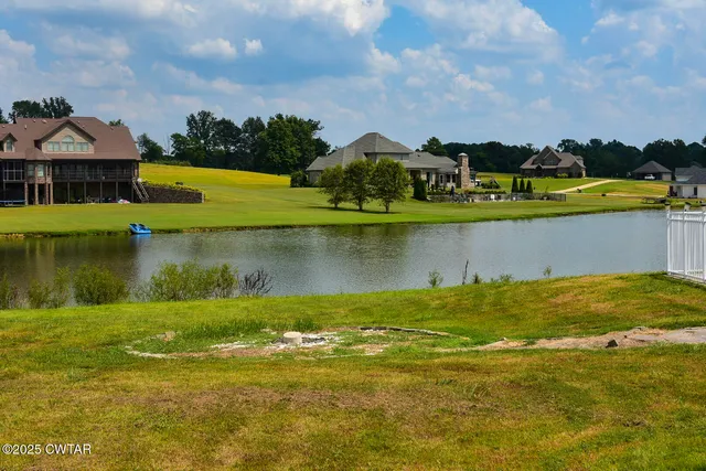 a view of a lake with houses in the background