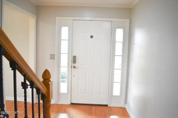a view of an entryway with wooden floor