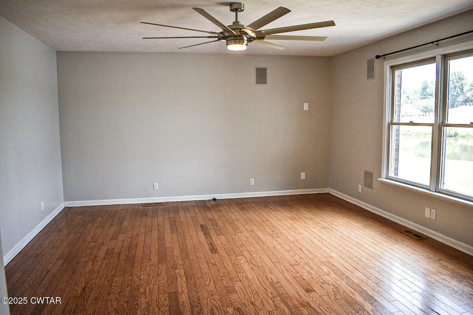 612 Wynridge Troy, TN 38260 - Photo 6 of 42 an empty room with wooden floor fan and windows