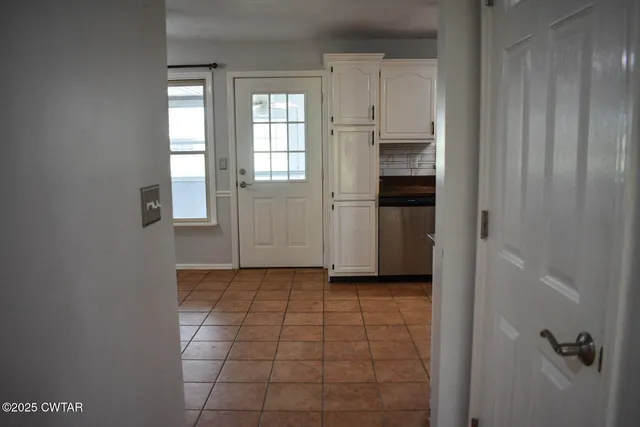 a view of a kitchen with an empty space and a window