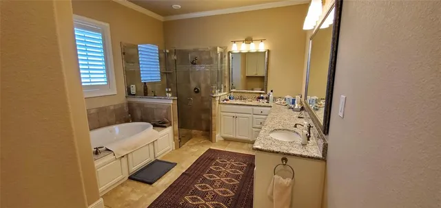 a bathroom with a sink a toilet a mirror and shower