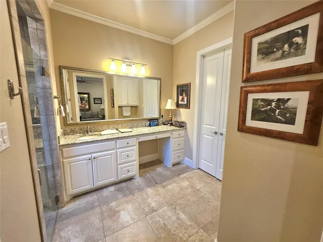 a large bathroom with a sink and a mirror