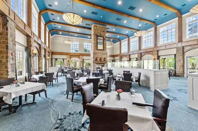 a living room with lots of furniture and a large window