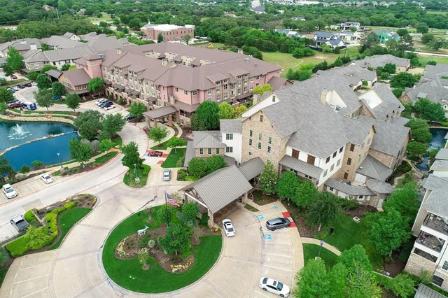 an aerial view of a house with garden space and street view