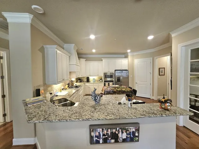 a view of a a kitchen counter top space and living room
