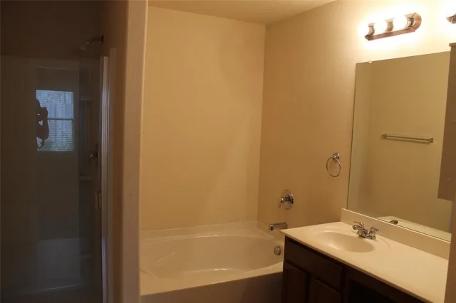 a bathroom with a bathtub and a sink