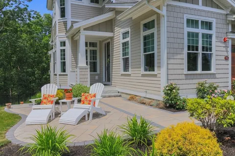 two chairs sitting in front of a house
