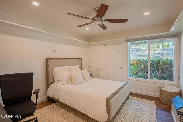 a bedroom with a large bed and a large window