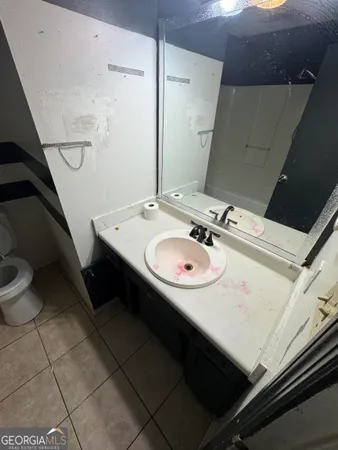 a bathroom with a sink toilet and mirror