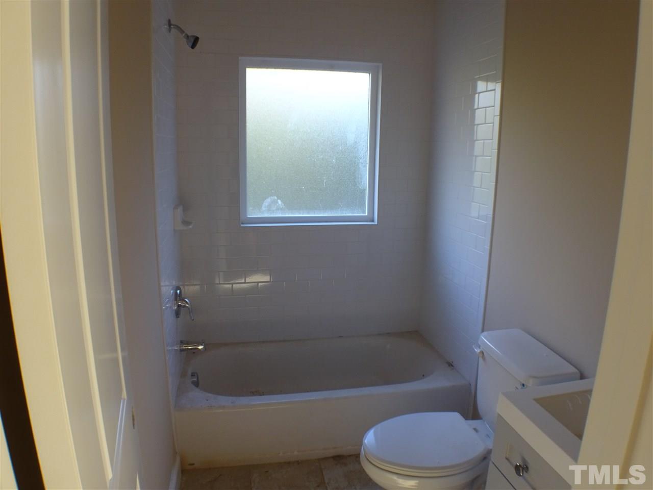 427 Lamont Street Raleigh, NC 27610 - Photo 9 of 13 a bathroom with a toilet and bathtub